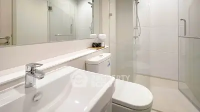 Modern bathroom with sleek fixtures and glass shower enclosure