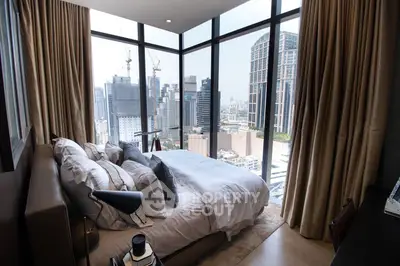 Luxurious bedroom with stunning city view, floor-to-ceiling windows, and elegant decor in urban high-rise.