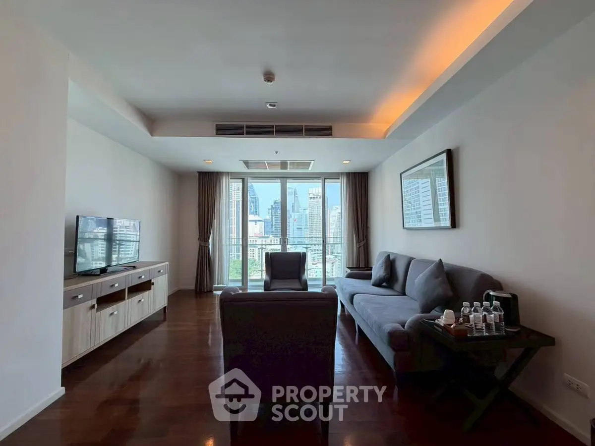 Spacious living room with modern furniture and city view, perfect for urban living.