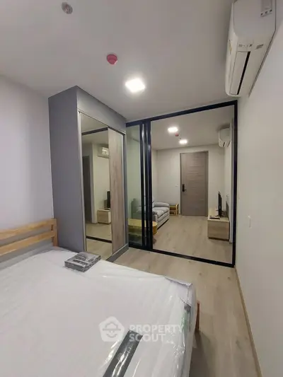 Modern bedroom with mirrored wardrobe and sliding glass doors