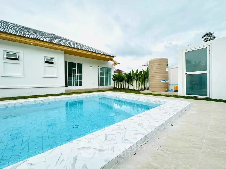 Luxurious modern home with private pool and elegant exterior design.