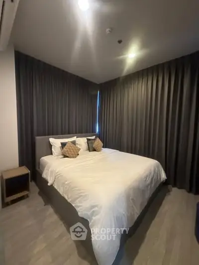 Cozy bedroom with modern decor and soft lighting, perfect for relaxation.