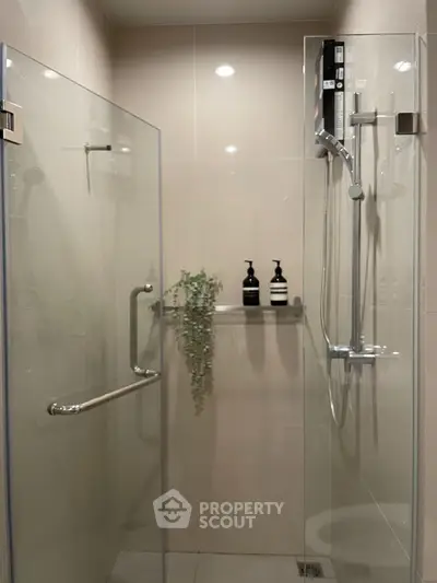 Modern bathroom with glass shower enclosure and sleek fixtures