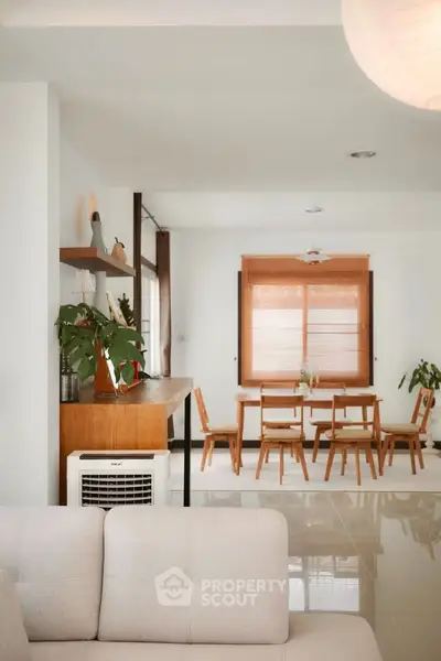 Stylish open living and dining area with modern decor and natural light.