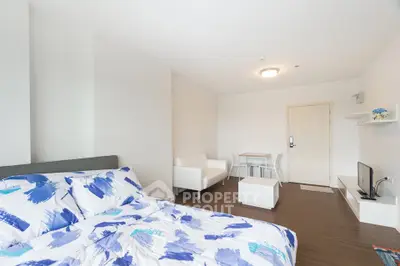 Modern studio apartment with cozy bed and minimalist decor