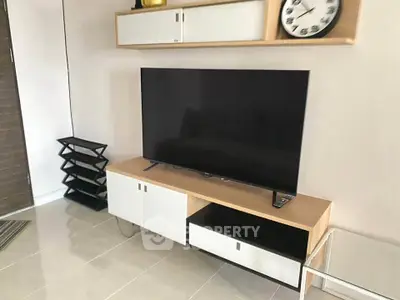 Modern living room with sleek TV stand and wall-mounted storage, ideal for contemporary homes.