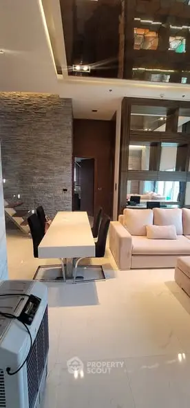 Luxurious modern living room with elegant dining area and plush seating.