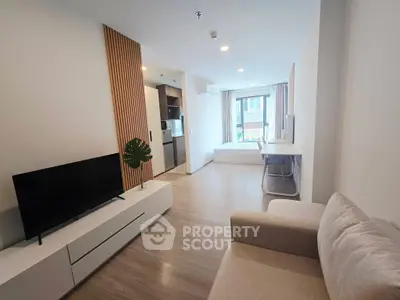 Modern studio apartment with open layout, featuring cozy living area and stylish kitchen.