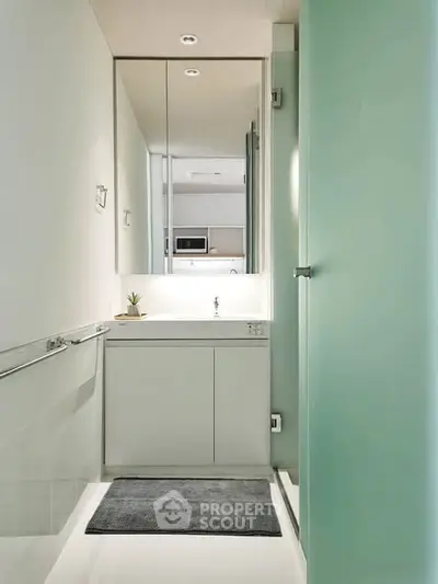 Modern minimalist bathroom with sleek design and large mirror