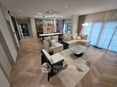 Luxurious open-plan living room with modern decor and elegant lighting