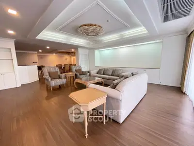 Spacious living room with elegant decor and ample seating in a luxurious apartment.
