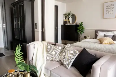 Stylish modern bedroom with cozy living area and elegant decor