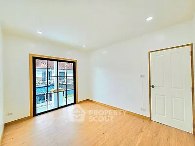 Bright empty room with wooden flooring and large window view