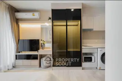 Modern studio apartment with sleek furniture, built-in appliances, and stylish decor.