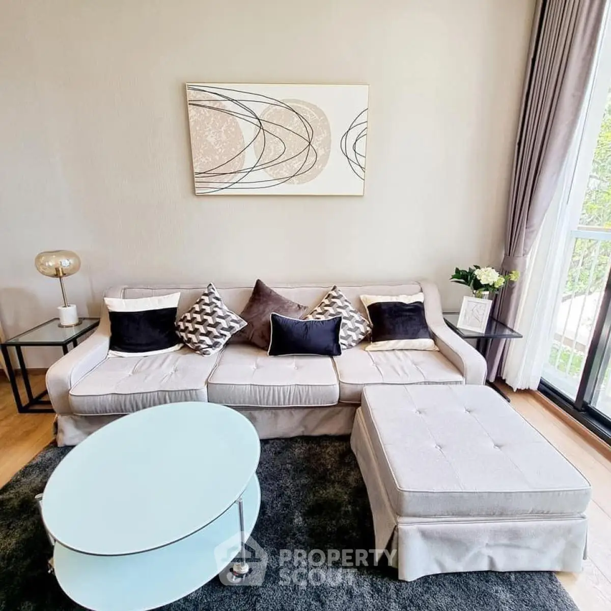 Stylish living room with modern decor and large window for natural light