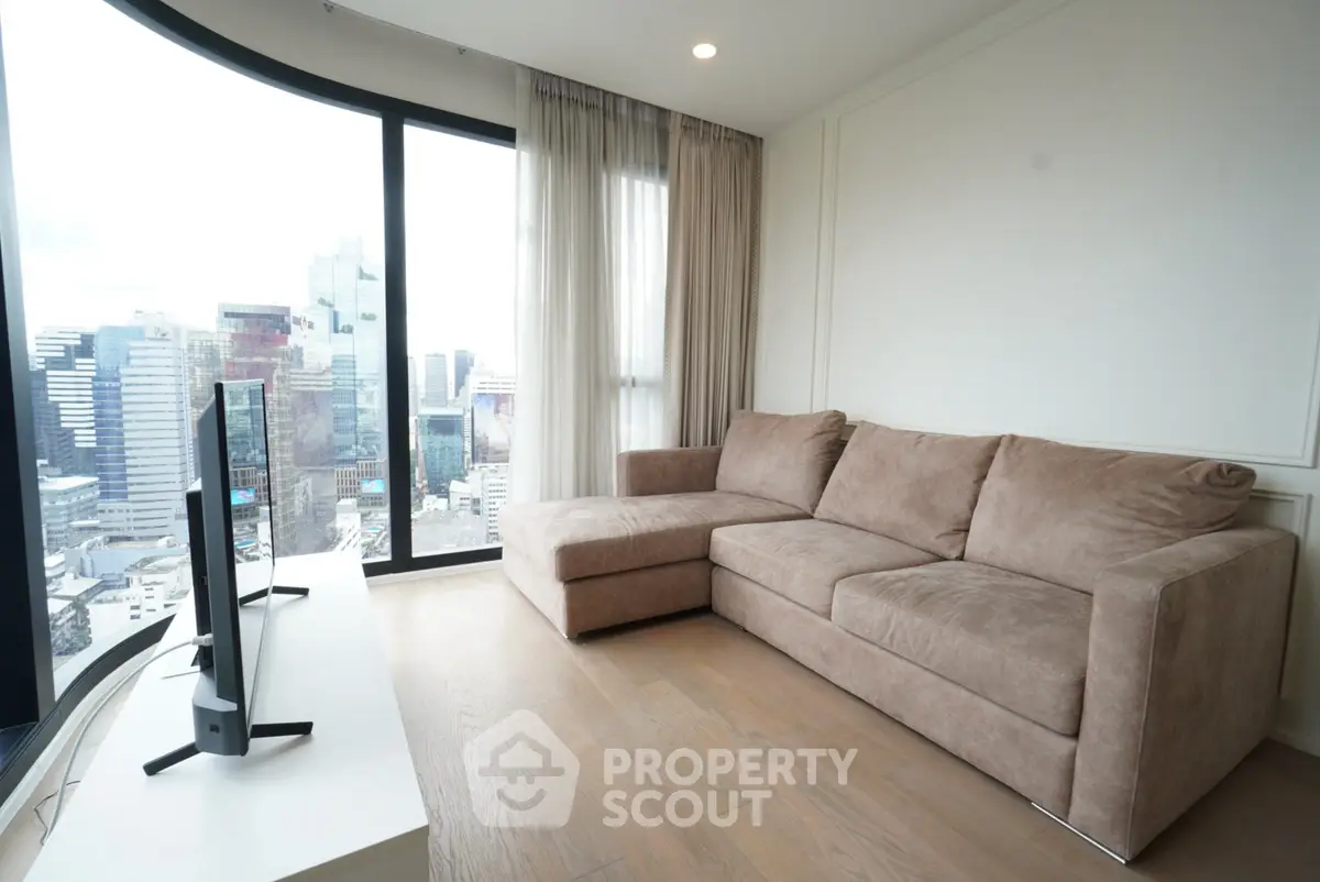Modern living room with panoramic city view and cozy sectional sofa.