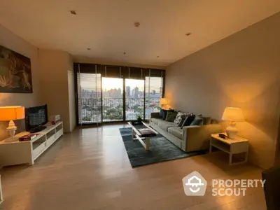 Spacious living room with city view, modern decor, and cozy ambiance.