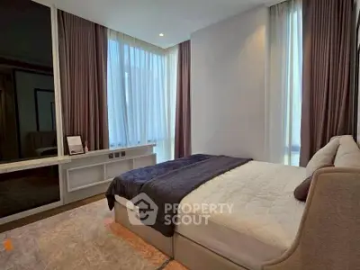 Luxurious modern bedroom with elegant decor and large windows.