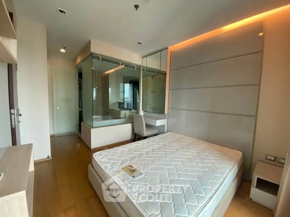 Modern bedroom with glass-enclosed bathroom and sleek design