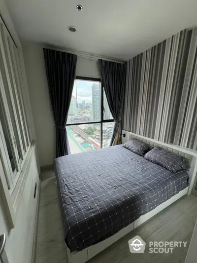 Cozy bedroom with city view and modern striped wallpaper