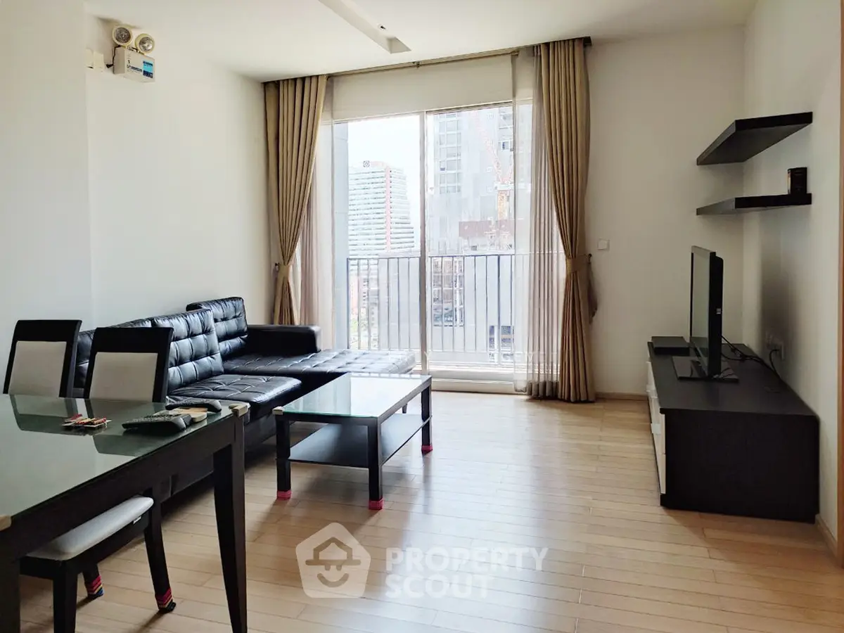 Modern living room with sleek furniture and city view, perfect for urban living.