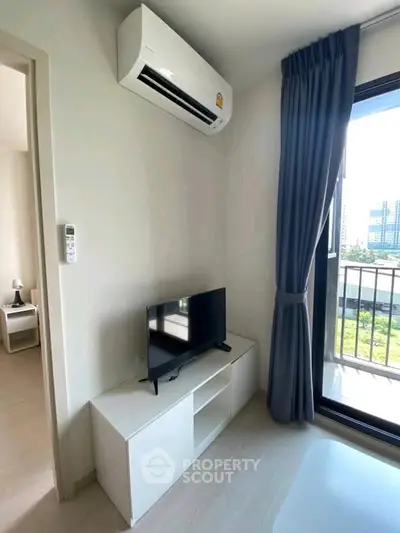 Modern living room with air conditioning and balcony view in a stylish apartment.