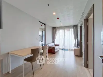 Spacious living room with modern decor and natural light in a stylish apartment.