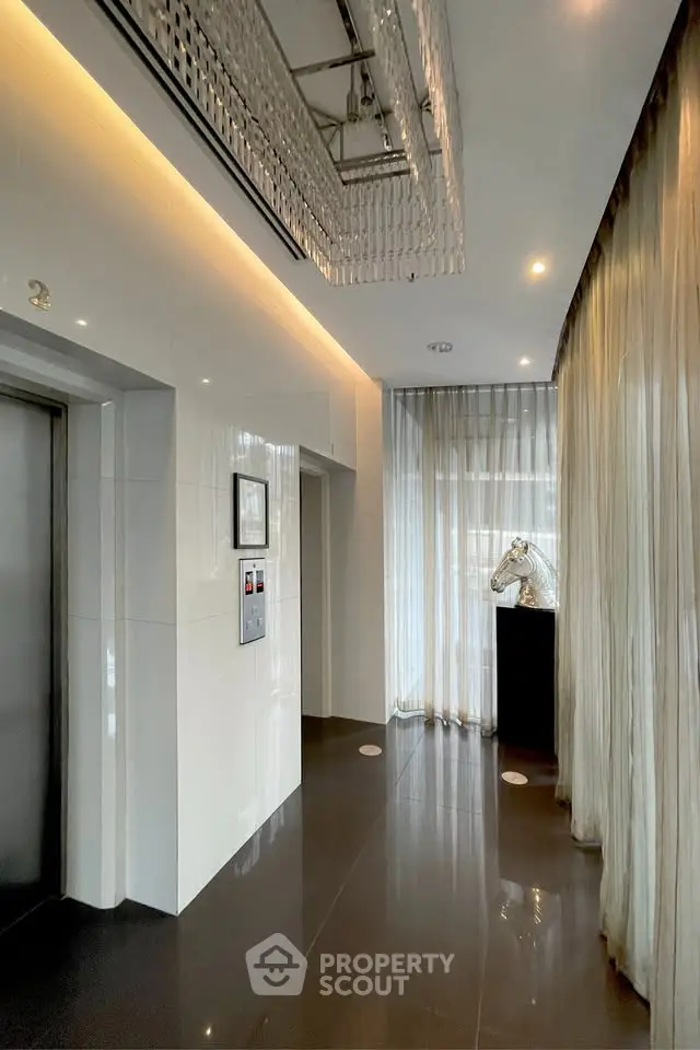 Luxurious building lobby with elegant chandelier and modern decor