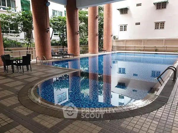 Luxurious residential pool area with elegant design and ample seating, perfect for relaxation and leisure.