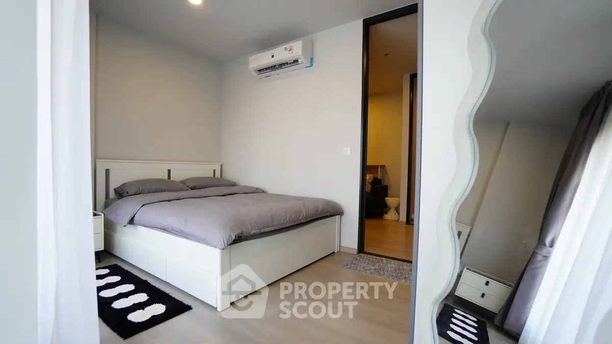 Modern bedroom with stylish decor and air conditioning in a cozy apartment.