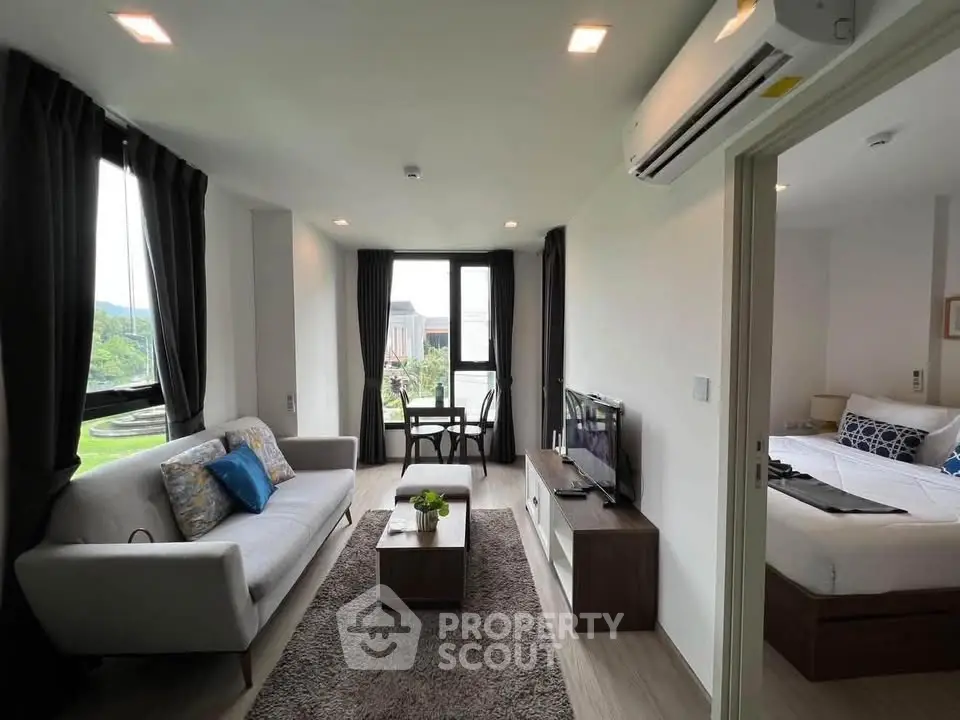 Modern living room with cozy sofa and large window offering scenic views