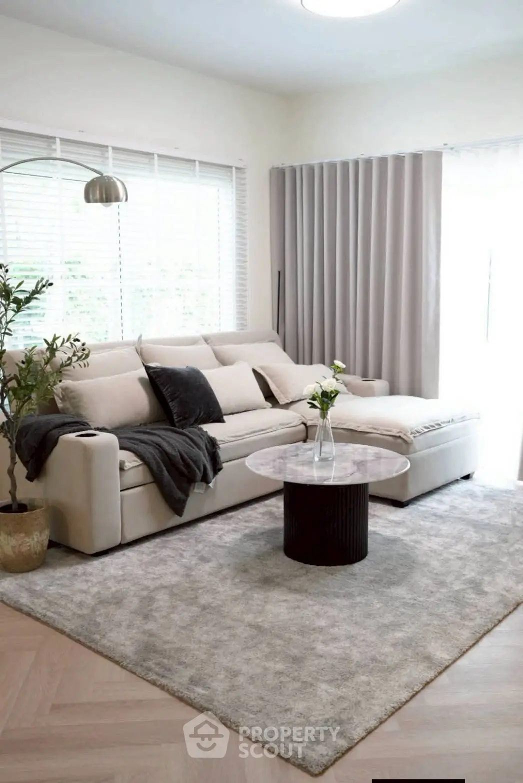 Modern living room with stylish sofa, elegant decor, and natural light