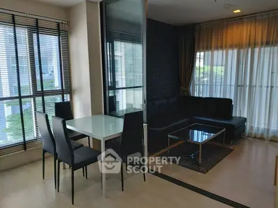 Modern living room with sleek furniture and large windows in a stylish apartment.