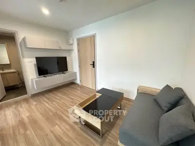 Modern living room with sleek furniture and wooden flooring