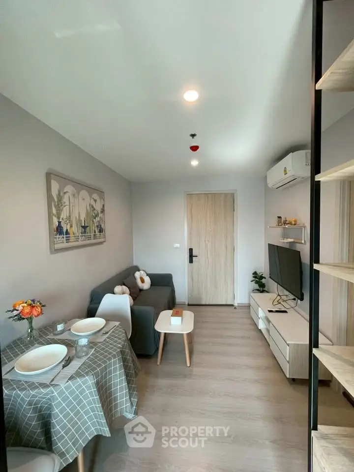 Modern living room with cozy seating and dining area, featuring stylish decor and natural light.