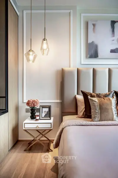 Luxurious bedroom with elegant decor and modern lighting fixtures.