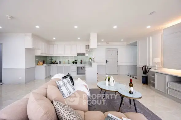 Spacious open-plan living room with modern kitchen and stylish decor