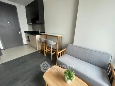 Modern studio apartment with sleek kitchen and cozy living area, perfect for urban living.