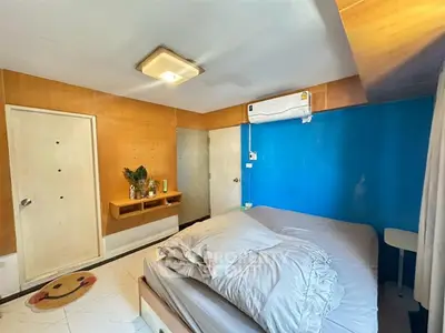 Cozy bedroom with modern decor and air conditioning in a stylish apartment.