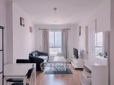 Bright and modern living room with stylish decor and large window view.