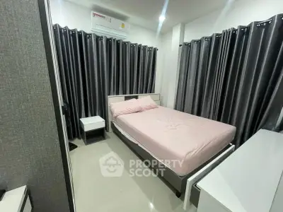 Modern bedroom with sleek design, featuring a comfortable bed and stylish curtains, perfect for relaxation.