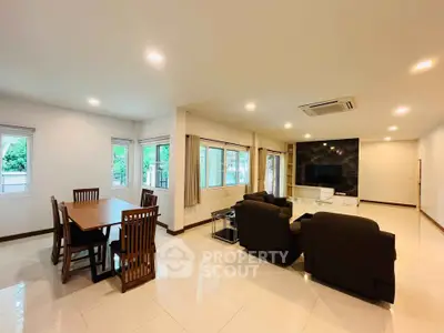 Spacious living room with modern furniture and large windows for natural light.