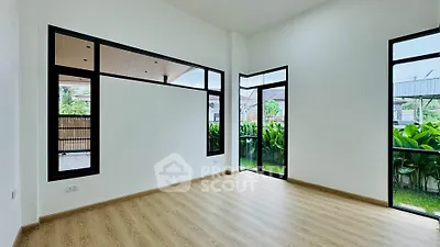 Spacious modern room with large windows and garden view, perfect for natural light lovers.