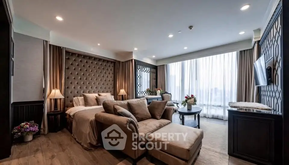 Luxurious living room with elegant decor and large windows offering natural light.