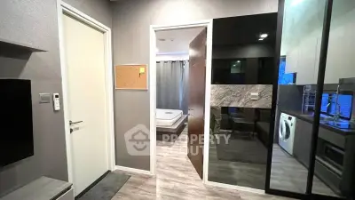 Modern apartment interior with open layout, featuring a cozy living area, sleek kitchen, and stylish bedroom.