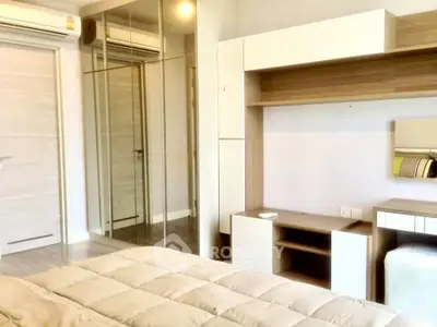 Modern bedroom with mirrored wardrobe and stylish shelving in a cozy apartment.