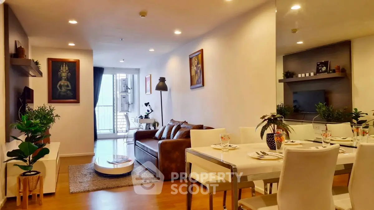 Modern living room with dining area, stylish decor, and balcony access in a cozy apartment.