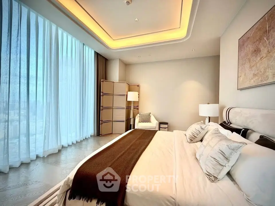 Luxurious bedroom with floor-to-ceiling windows and elegant decor