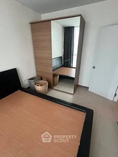 Spacious bedroom with mirrored wardrobe and modern design