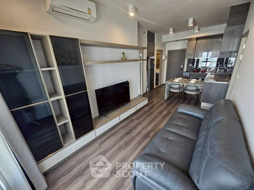 Modern living room with sleek furniture and open kitchen layout